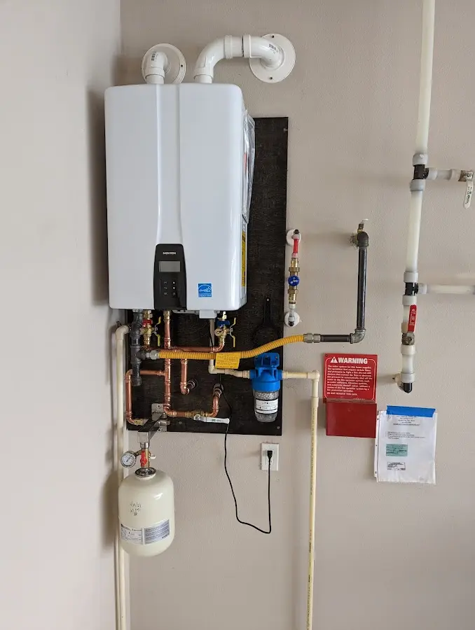 Professional plumber installing copper piping in a Pismo Beach home